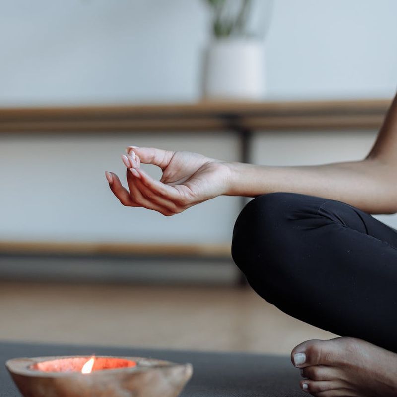 Close-up of a person's hands in a meditative yoga mudra.